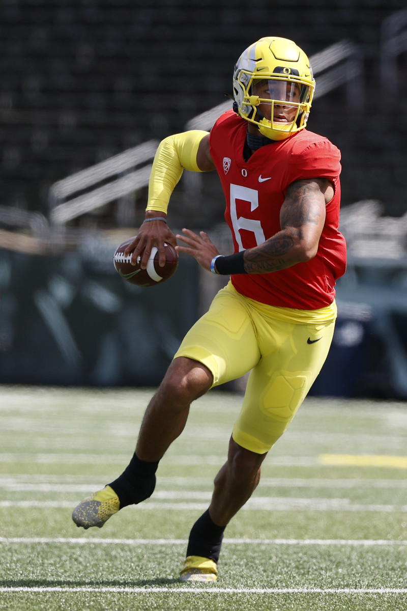 Quarterback Robby Ashford loads up for a throw on the run in Oregon football's spring game.